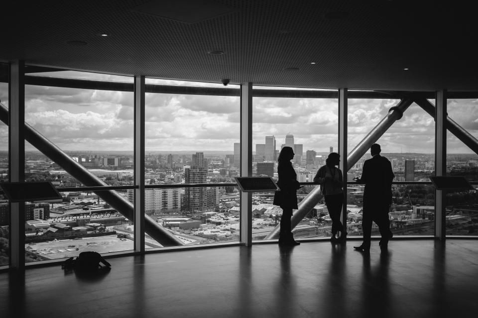 Colleagues silhouetted against a city view